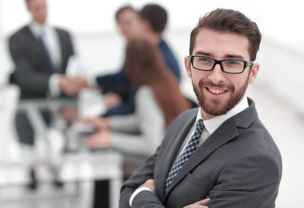 smiling businessman on background of office - Fotó, kép