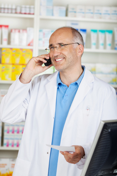 cheerful mature pharmacist on the phone - Fotoğraf, Görsel
