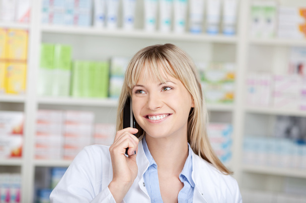 confident pharmacist using telephone - 写真・画像
