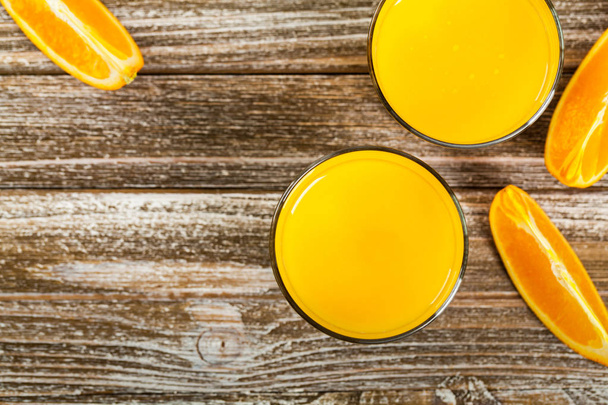 Orange Juice on Wooden Background. Selective focus. - Photo, Image
