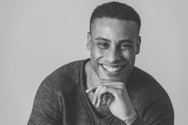 Portrait of young attractive stylish african american man model posing in casual clothes against neutral background looking sexy with beautiful eyes. In People, Beauty and fashion concept. - 写真・画像