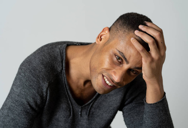 Portrait of young attractive stylish african american man model posing in casual clothes against neutral background looking sexy with beautiful eyes. In People, Beauty and fashion concept. - 写真・画像