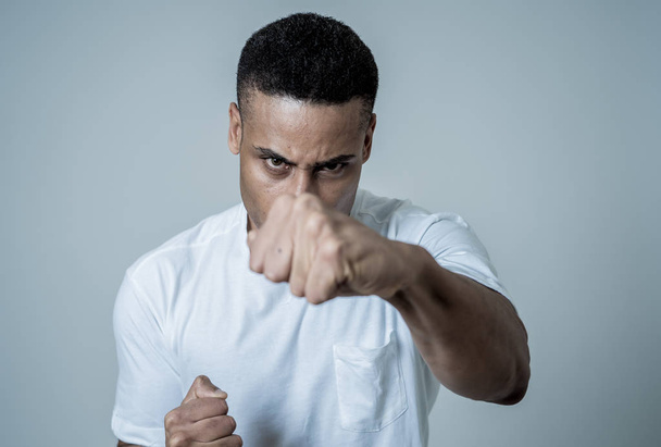 Close up portrait of an attractive young african american man with angry face looking furious and crazy having an argument or fight. In People, Human facial expressions and negative emotions. - Foto, Imagen