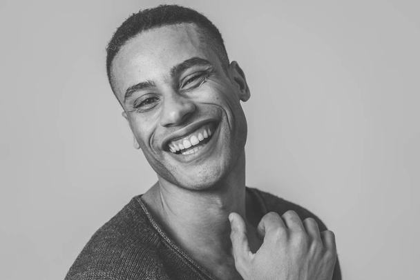Portrait of happy african american man having fun and joy smiling at the camera and looking to something that makes him lough. In Human emotions facial expressions, happiness and beauty concept. - Fotoğraf, Görsel