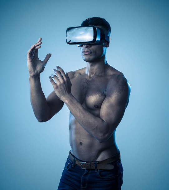 Attractive african american man using augmented VR glasses exploring 3d world feeling excited about simulation, new sensations and desires. In virtual reality, innovation and new technology concept. - Φωτογραφία, εικόνα