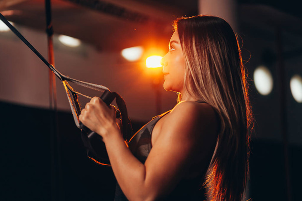 Young fitness woman training with trx fitness straps - Fotoğraf, Görsel
