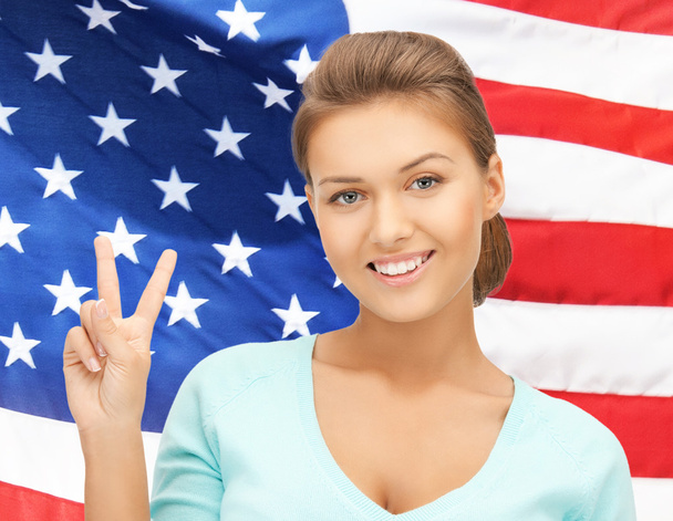 Young woman showing victory or peace sign - Foto, immagini