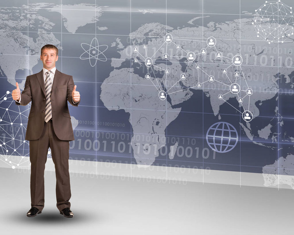 Businessperson showing ok on abstract background with world map and graphs - Foto, Imagen