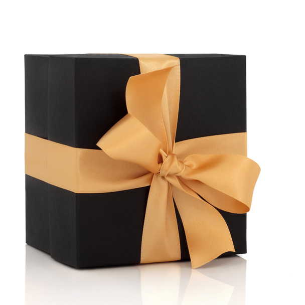 Caja de regalo negra con lazo de oro
 - Foto, imagen