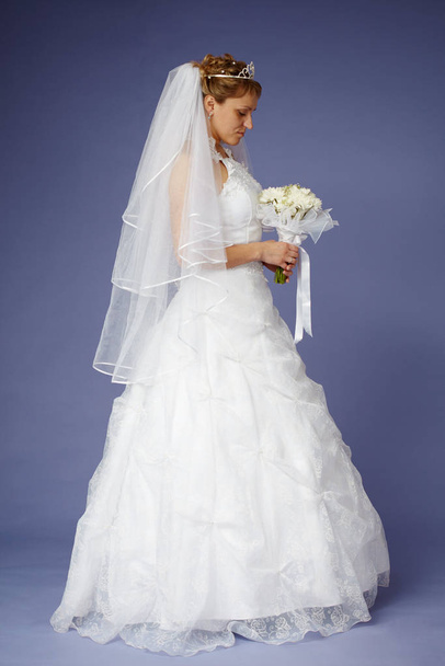 Young bride in white wedding dress with a bouquet - Photo, Image