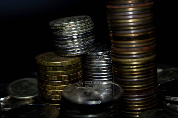 Coins stack on black background in concept wall and strong money. - Foto, Imagem