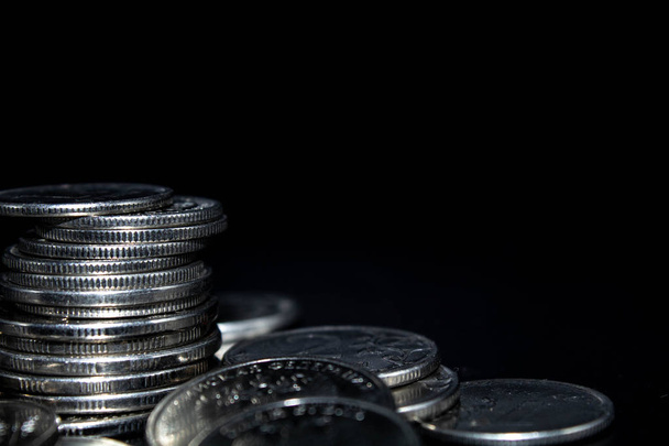 Coins stack on black background in concept wall and strong money. - Foto, Imagem