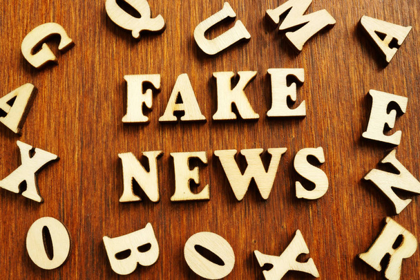 Fake news from wooden letters on desk. - 写真・画像