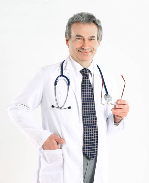 Portrait of mature medical doctor with white coat and stethoscope on isolated background - Valokuva, kuva