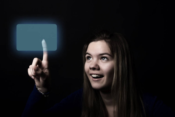 Portrait of a young beautiful girl touching digital screen - Fotó, kép