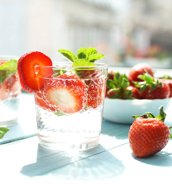 refreshing drinks with fresh strawberries on blue wooden surface - Φωτογραφία, εικόνα