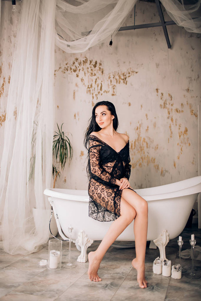 Sexy woman wearing black lace robe in bathroom - Foto, imagen