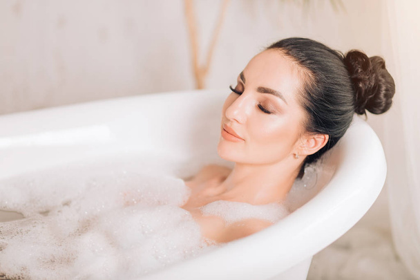 Beautiful sexy woman in bubble bathtub - Фото, изображение
