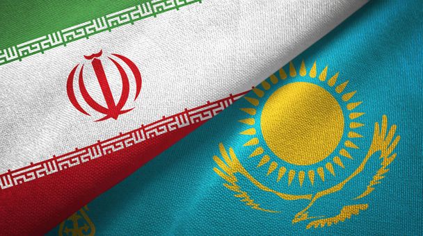 Irán és Kazahsztán két zászló textil ruhával, szövet textúra - Fotó, kép
