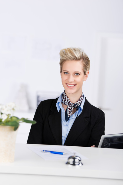 Receptionist Smiling At Desk - Fotoğraf, Görsel