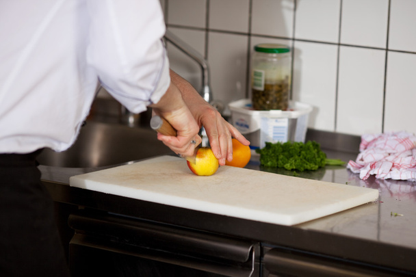 Chef Cutting An Apple On Chopping Board - Valokuva, kuva
