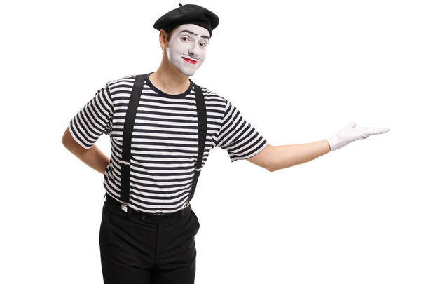 Mime gesturing welcome with his hand isolated on white background - 写真・画像