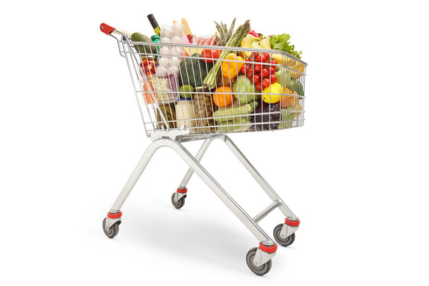 Shopping trolley filled with different food products, fruits and vegetables isolated on white background - Fotografie, Obrázek