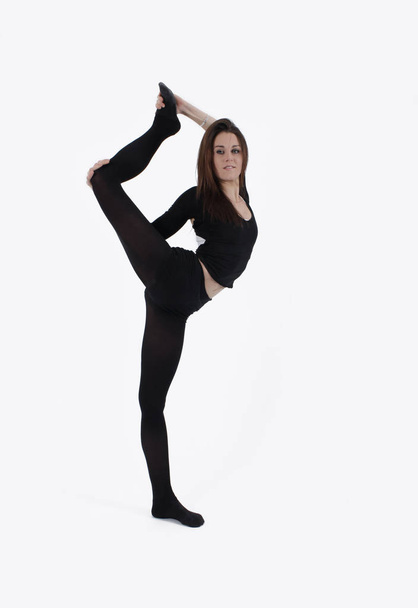 Young gymnast in black looking at the camera - Valokuva, kuva