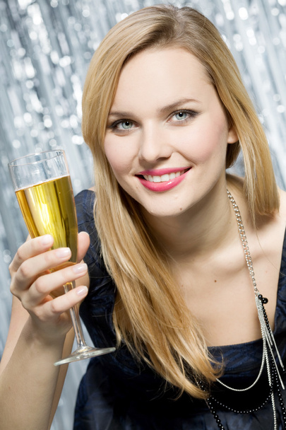 Smiling woman with glass of champagne - 写真・画像