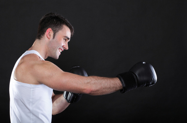 Portrait sportsman boxer in studio dark background - Foto, afbeelding