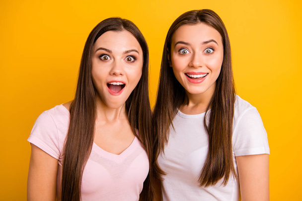 Close up photo two people beautiful funky funny she her ladies models open mouth not believe great amazing news information wear white pink casual t-shirts isolated yellow background - Foto, Imagem