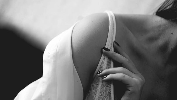 Hands of woman undressing white bra - Фото, изображение