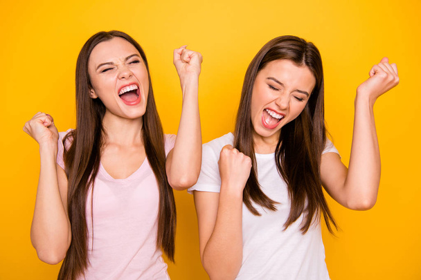 Close up photo satisfied beautiful ladies enjoy great good travel trip long hair perfect scream shout yeah raise fists closed eyes fan goal isolated light-colored clothing vivid background - Valokuva, kuva