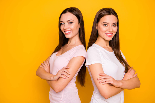 Portrait of nice-looking cute charming sweet winsome lovely attractive cheerful cheery straight-haired ladies standing back to back best pals isolated over bright vivid shine background - 写真・画像
