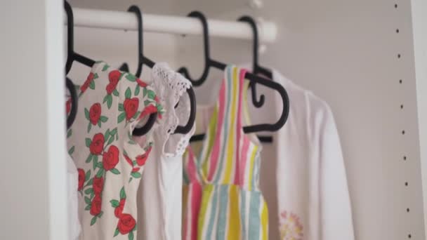 A közelről egy kislány ruhák lóg egy szekrényben - Felvétel, videó
