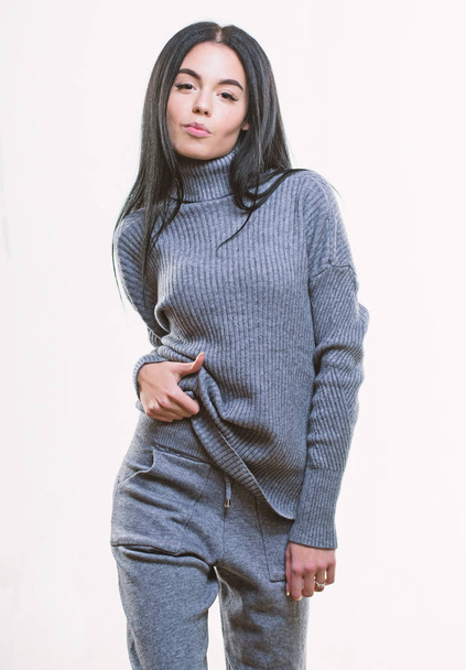 Casual style fashion for every day. Female knitwear. Fashionable knitwear. Knitwear concept. Feel warm and comfortable. Woman wear grey textile suit blouse and pants. Warm comfortable clothes - Фото, зображення