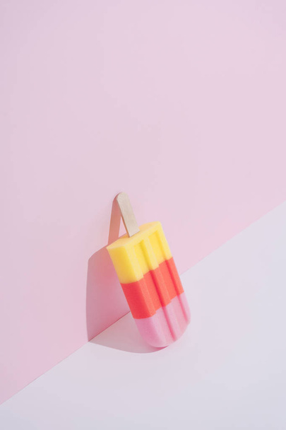 Colorful Ice cream popsicle on pastel pink background. Minimal summer concept  - Photo, Image