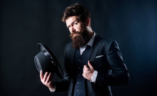 Retro fashion hat. Man with hat. Vintage fashion. Man well groomed bearded gentleman on dark background. Male fashion and menswear. Formal suit classic style outfit. Elegant and stylish hipster - Фото, изображение