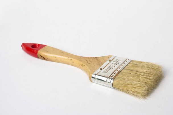 A small wooden handled paint brush isolated against a white background - Foto, imagen