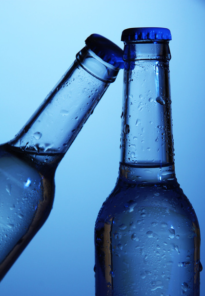 Water bottles on blue background - Foto, Imagem