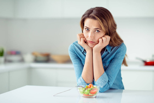 Portrait of her she nice lovely charming attractive sad dull disappointed gloomy moody brown-haired lady dislike new green mix vegs vitamin salad in light white interior style kitchen - Fotografie, Obrázek