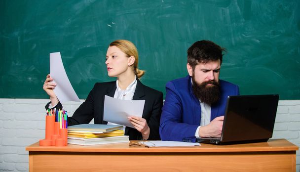 teacher and student on exam. business couple use laptop and documents. back to school. Formal education. serious businessman and secretary. paper work. office life. All the research is online - Φωτογραφία, εικόνα