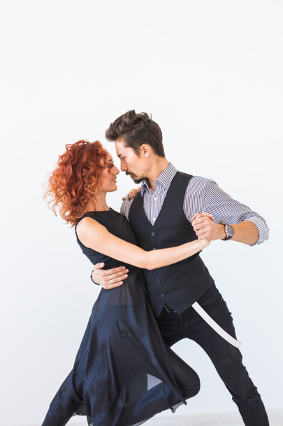 Social dance, bachata, kizomba, tango, salsa, people concept - Young couple dancing over white background - Photo, image