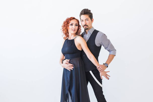 Social dance, kizomba, tango, salsa, people concept - beautiful couple dancing bachata on white background with copy space - Foto, afbeelding