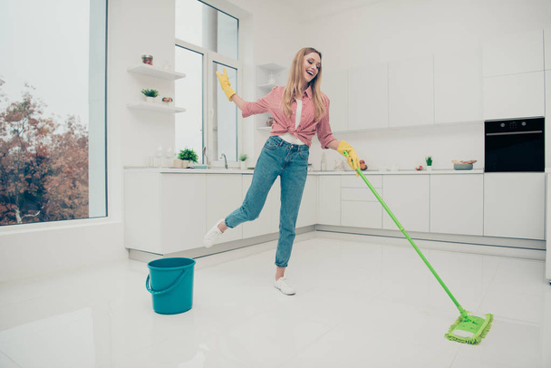 Full length body size photo beautiful domestic duties she her lady wash white shiny floor dance listen playlist audio sound track wear jeans denim casual checkered plaid shirt bright light kitchen - Photo, Image