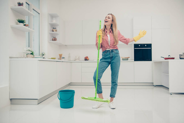 Full length body size photo beautiful busy nice duties she her lady wash white floor funky housemaid karaoke day singing mop crazy wear jeans denim casual plaid checkered shirt bright light kitchen - Photo, Image