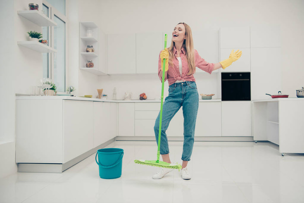 Full length body size photo beautiful busy nice duties she her lady wash white floor funky housemaid karaoke day singing mop crazy wear jeans denim casual plaid checkered shirt bright light kitchen - Fotoğraf, Görsel