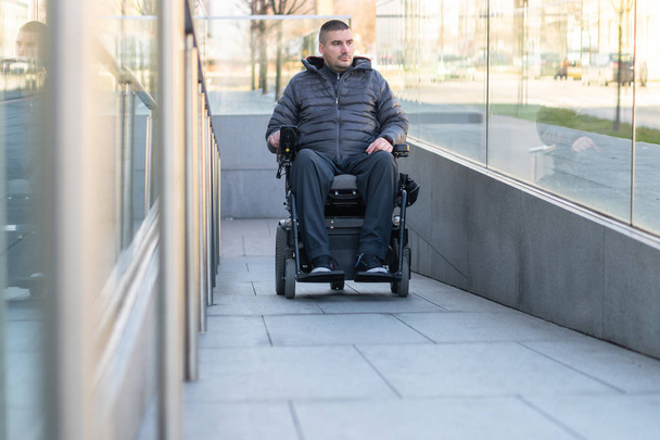 Man in a electric wheelchair using a ramp - Фото, изображение