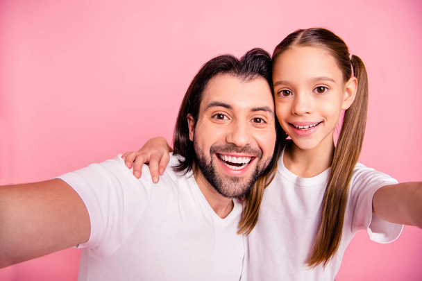 Close up photo beautiful she her little lady he him his single dad rest relax make take selfies hug embrace cuddle toothy wear casual white t-shirts denim jeans isolated pink bright background - Foto, immagini