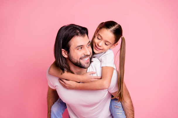 Close up photo beautiful adorable she her little lady he him his daddy dad hold little princess piggyback hands arms funny funky wear casual white t-shirts denim jeans isolated pink bright background - Foto, afbeelding